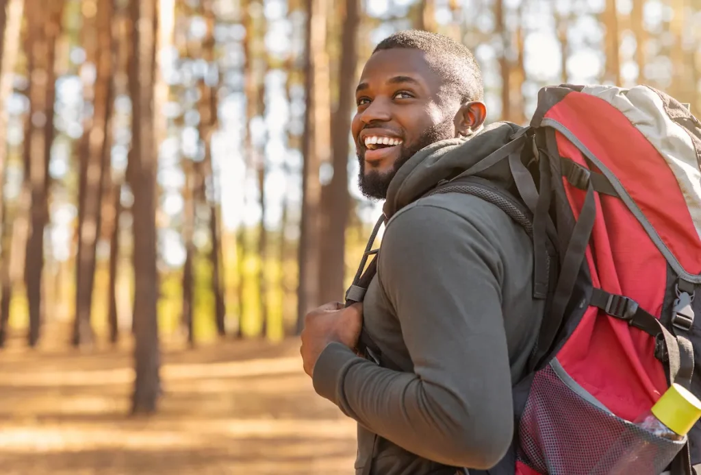 happy man hiking through the woods