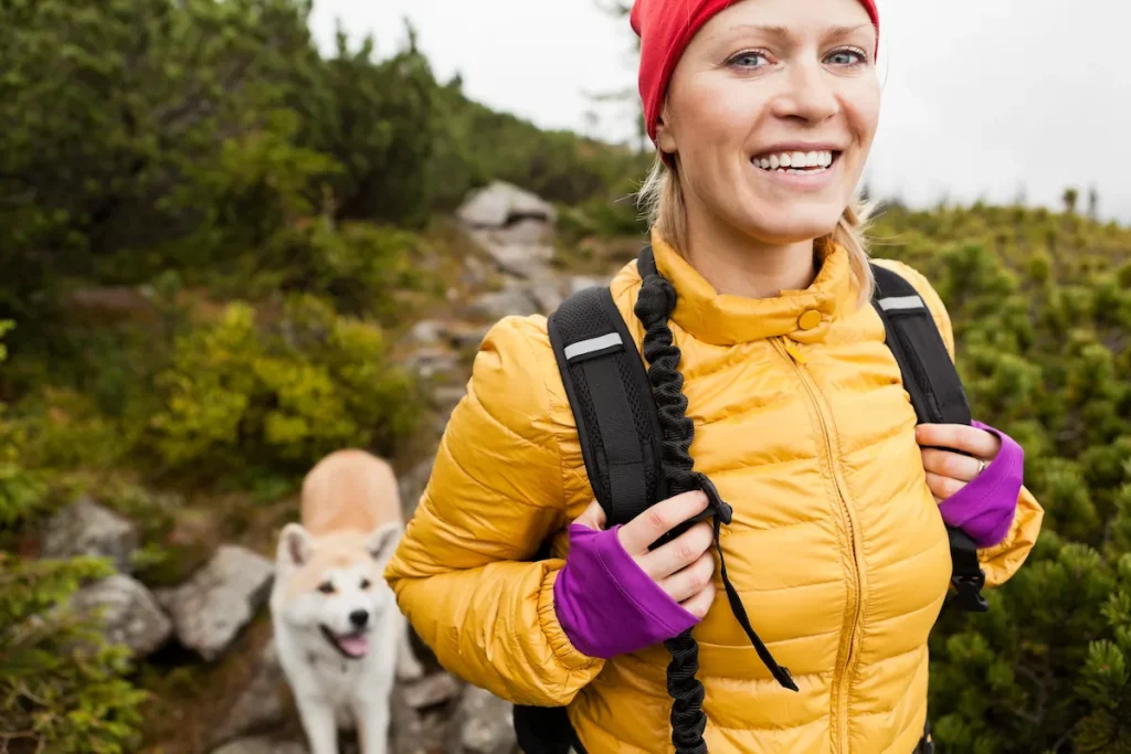 woman hiking with dog