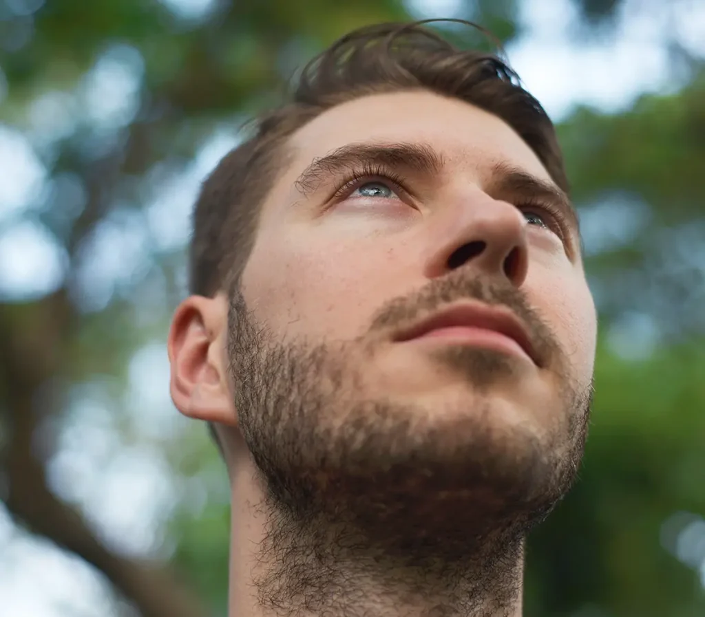 man with floaters in eye looking up at the sky