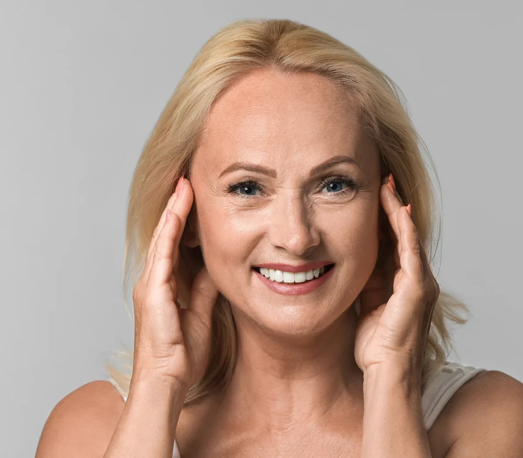 happy mature woman with refreshed look touching her face